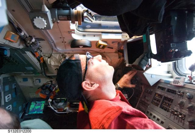 NASA image: Antonelli looks out window in the aft FD on Space Shuttle Atlantis