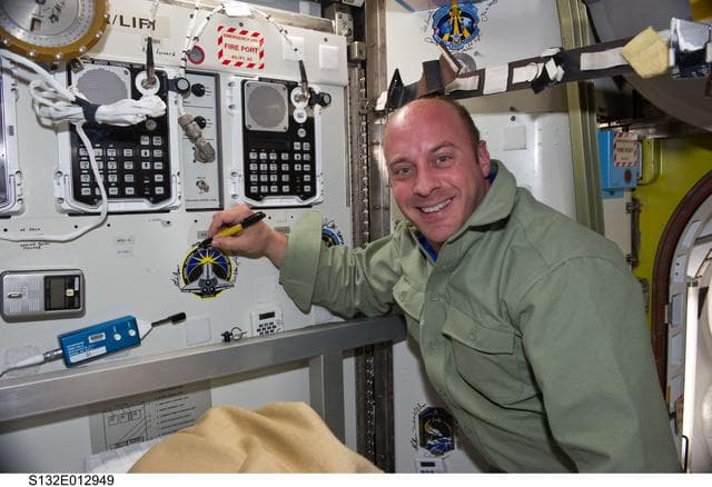 NASA image: Reisman signs mission patch in the A/L during Joint Operations