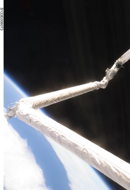 NASA image: RMS/OBSS inspection of shuttle thermal tile system