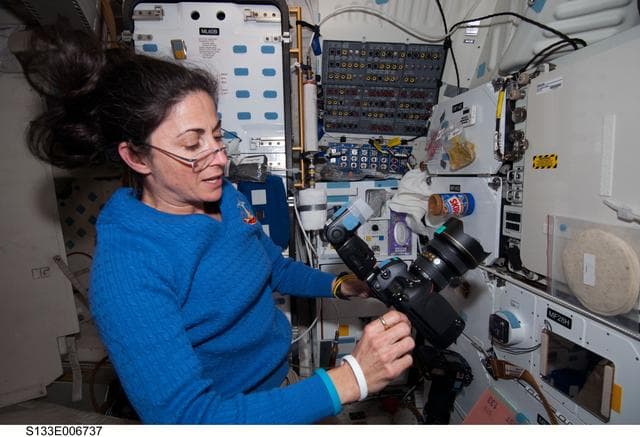 NASA image: Stott on middeck with camera