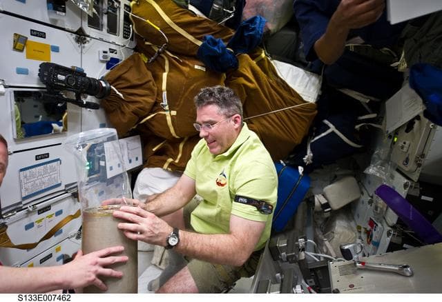 NASA image: Bowen with LiOH cans on Discovery middeck