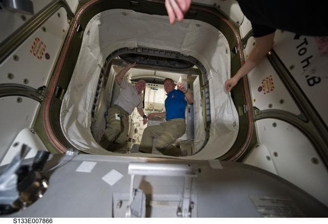 NASA image: STS-133 and Expedition 26 crew enter PMM (Permanent Multipurpose Module)