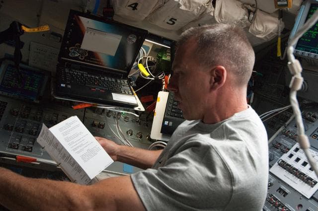 NASA image: View of STS-134 MS Feustel working on the Flight Deck