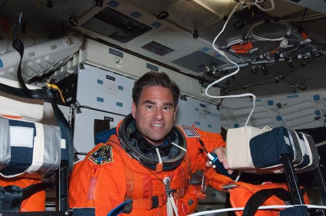 NASA image: View of STS-134 MS Chamitoff posing for a photo on the Middeck