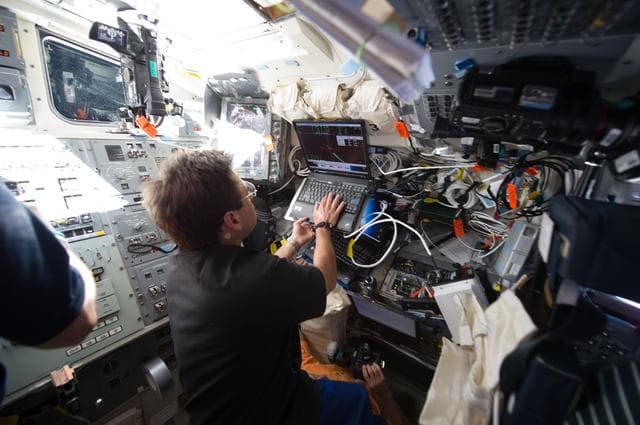 NASA image: View of STS-134 MS Chamitoff working on the Flight Deck