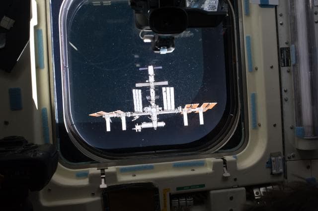 NASA image: View of the ISS as seen through a Flight Deck Window during Approach