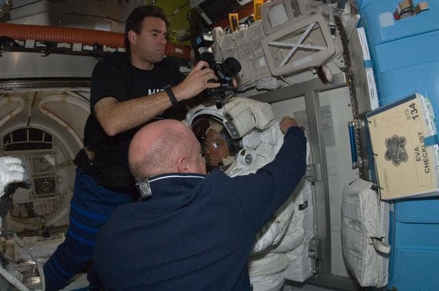 NASA image: STS-134 Crew Members working in the Airlock at the end of EVA-3