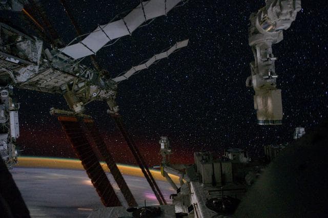 NASA image: Partial view of the ISS and Earth's Horizon at Night