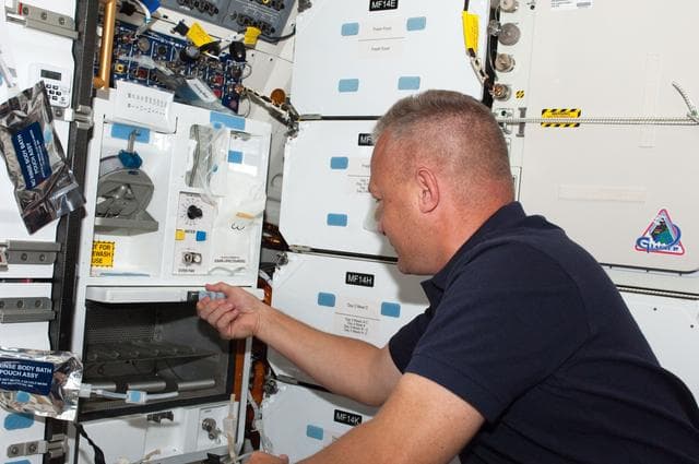 NASA image: Hurley Prepares a Meal on Atlantis Middeck