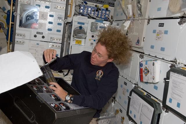 NASA image: Magnus works with RASV Payload on Atlantis Middeck