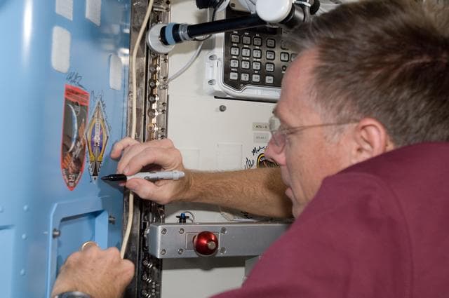 NASA image: Ferguson Signs Mission Patch in A/L
