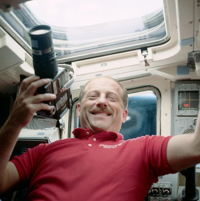 NASA image: STS-26 Commander Hauck holds camera on Discovery's, OV-103's, aft flight deck