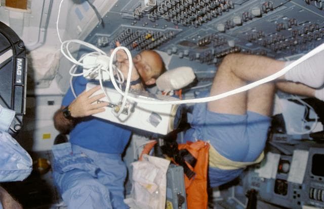 NASA image: STS-29 Discovery, OV-103, Pilot Blaha with IMAX camera on aft flight deck