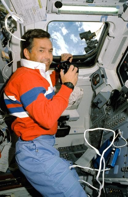 NASA image: STS-30 Pilot Grabe uses 35mm camera on aft flight deck