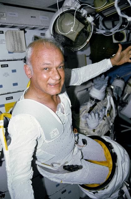 NASA image: STS-31 MS McCandless in LCVG removes EMU lower torso on OV-103's middeck