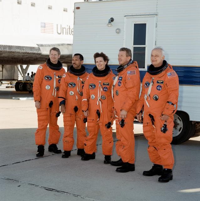 NASA image: STS-31 crew poses on EAFB concrete runway after egressing OV-103