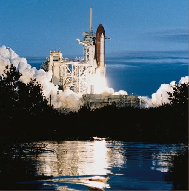 NASA image: STS-32 Columbia, OV-102, liftoff from KSC LC Pad 39A is reflected in waterway