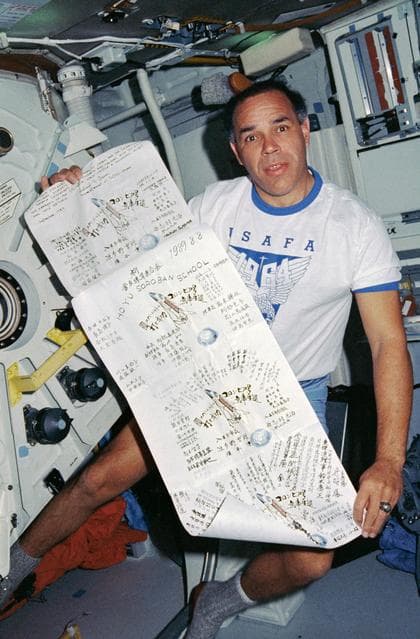 NASA image: STS-33 Commander Gregory displays Japanese student banner on OV-103's middeck