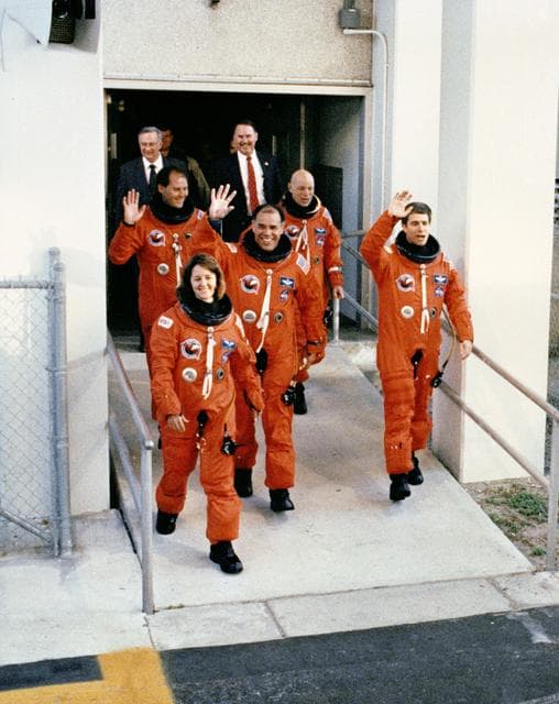 NASA image: STS-33 crewmembers, wearing LESs, leave KSC O&C Bldg for launch pad