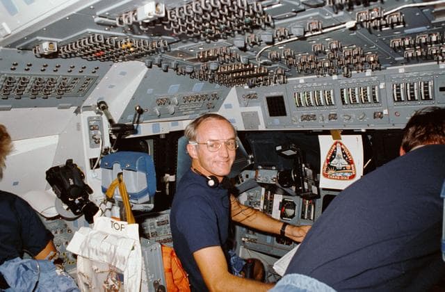 NASA image: STS-34 Commander Williams looks away from forward flight deck controls
