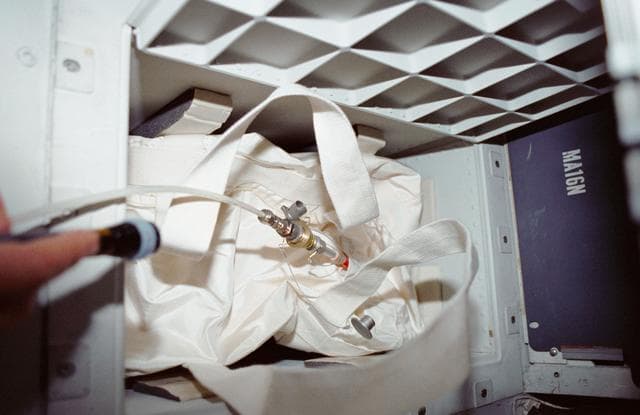 NASA image: STS-35 stowage volume G with contingency water container (CWC) onboard OV-102