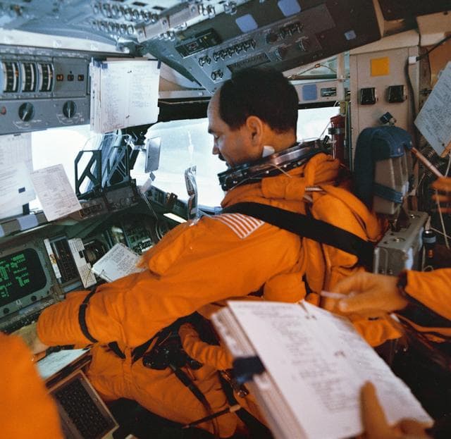 NASA image: STS-35 Pilot Gardner with descent checklist on OV-102's forward flight deck