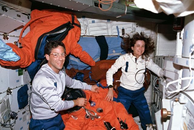 NASA image: STS-37 crewmembers check launch and entry suits (LESs) on OV-104's middeck