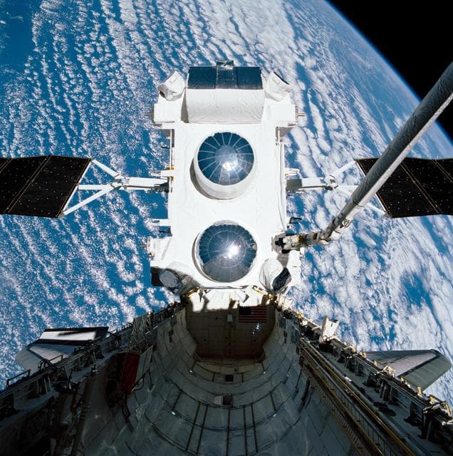 NASA image: STS-37 Gamma Ray Observatory (GRO) held by RMS over OV-104's payload bay