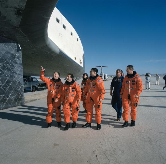 NASA image: STS-37 crewmembers inspect the underside of Atlantis, OV-104, at EAFB