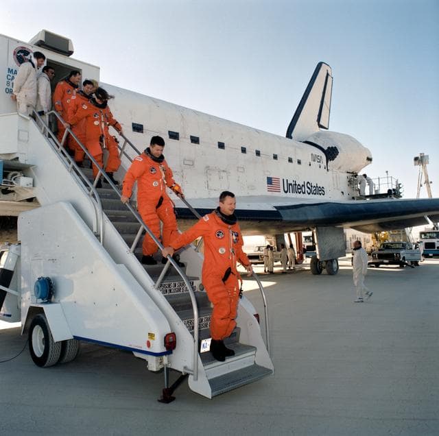 NASA image: STS-37 crewmembers egress OV-104 via stairway after landing at EAFB