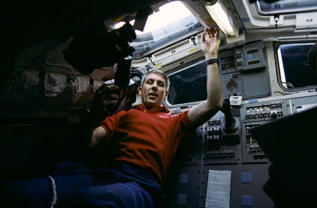 NASA image: STS-38 Mission Specialist (MS) Springer uses camera on OV-104 aft flight deck