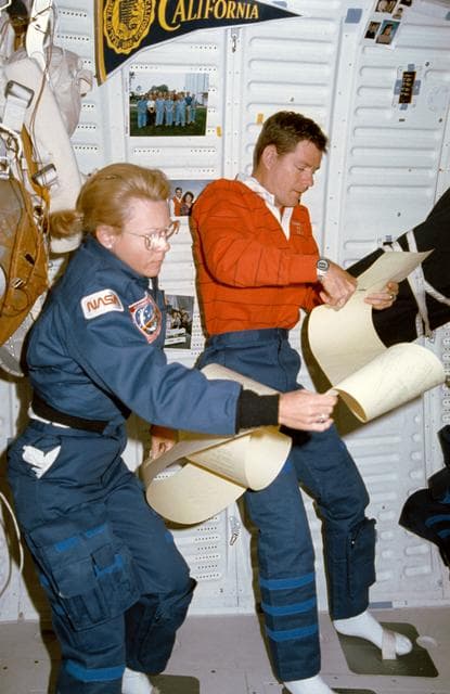 NASA image: STS-40 MS Seddon & Commander O'Connor review TAGS printout on OV-102 middeck