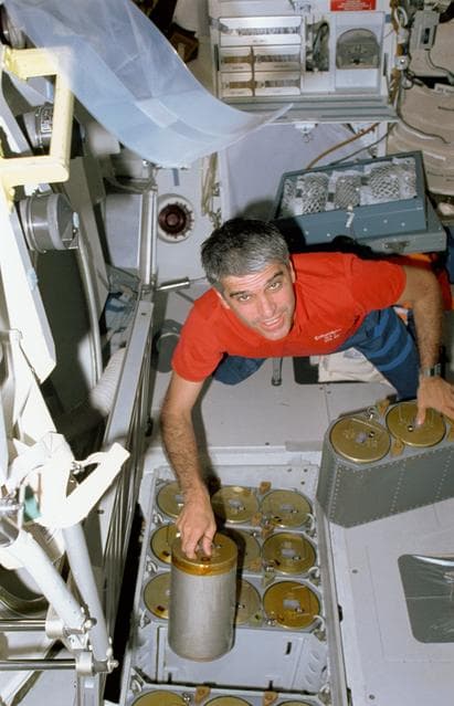 NASA image: STS-40 Pilot Gutierrez changes LiOH canisters on OV-102's middeck