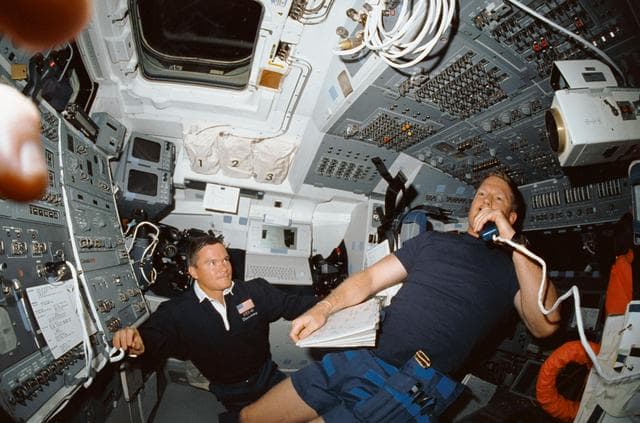 NASA image: STS-41 crew communicates with ground controllers from OV-103's flight deck