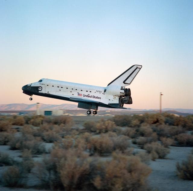 NASA image: STS-41 Discovery, OV-103, glides over concrete runway 22 at EAFB, California