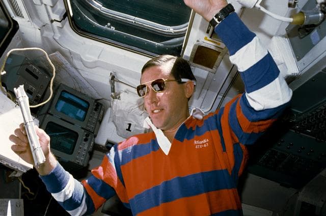 NASA image: STS-43 Pilot Baker reviews checklist on OV-104's aft flight deck