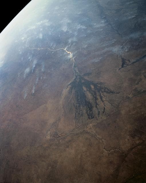 NASA image: Panoramic Okavango Swamp, Botswana and Fires in Angola, Africa