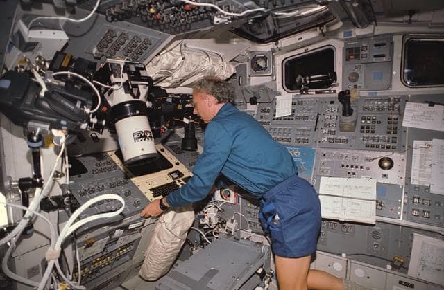 NASA image: STS-45 Payload Specialist Frimout at controls on OV-104's aft flight deck