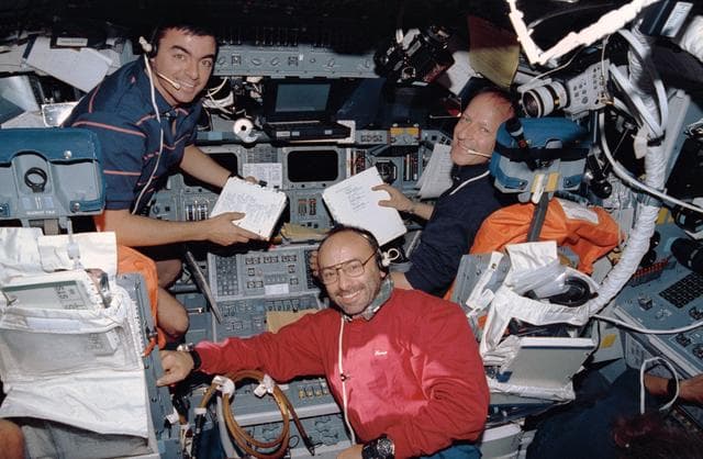 NASA image: STS-46 "blue" shift crewmembers look up from work on OV-104's flight deck