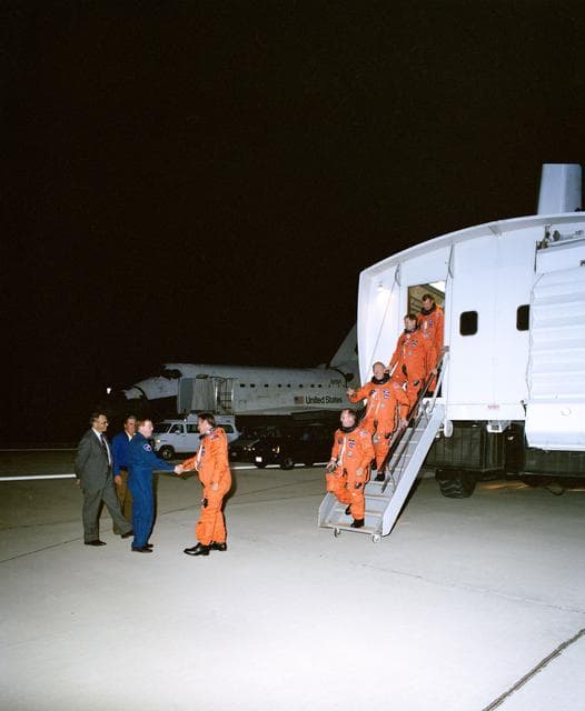 NASA image: STS-48 crew, exiting CTV, is greeted by astronaut Richards at EAFB, Calif