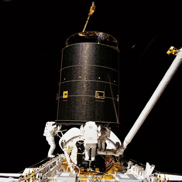 NASA image: STS-49 crew captures INTELSAT VI above OV-105's payload bay (PLB) during EVA