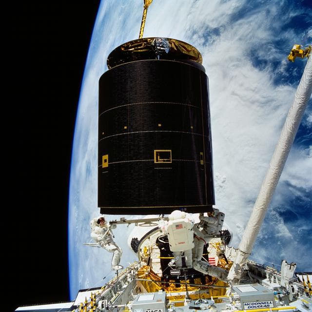 NASA image: STS-49 crew captures INTELSAT VI above OV-105's payload bay (PLB) during EVA
