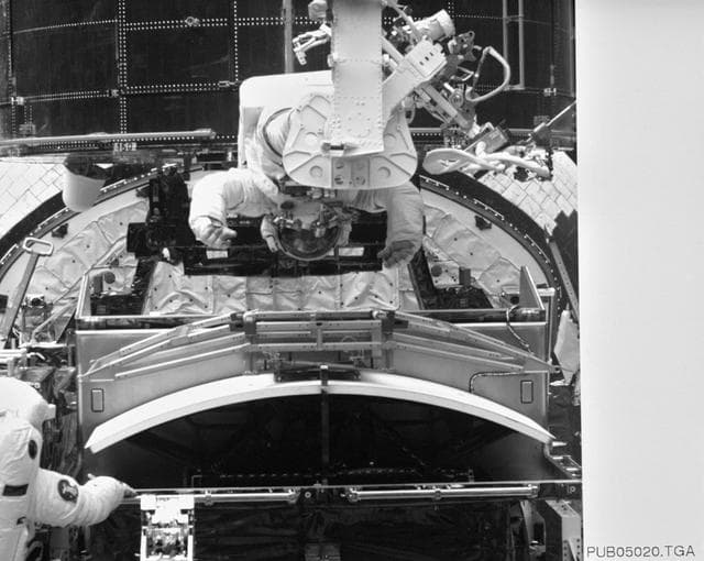 NASA image: Astronaut Jeffrey Hoffman on RMS robot arm during HST repairs