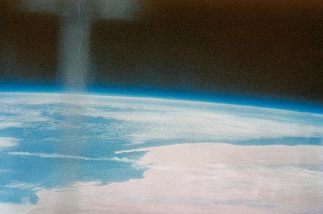NASA image:    Earth and sky views taken with hand-held camera during Mercury-Atlas 7 