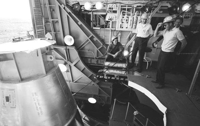 NASA image: ASTRONAUT COOPER, GORDON L., JR. - TECHICIANS - ATLAS BOOSTER 130-D - HOISTED - GANTRY - CAPE