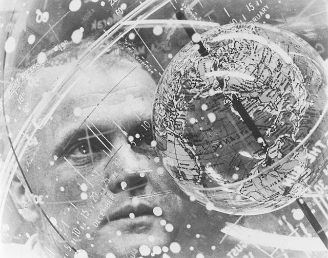 NASA image: Astronaut John Glenn looks into a  globe