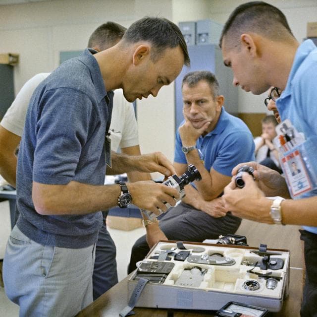 NASA image: Astronaut Michael Collins inspects camera during prelaunch activity