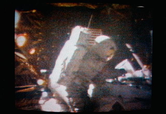 NASA image: Astronaut David Scott performs the act of cancelling the first Apollo 15 commemorative postage stamp