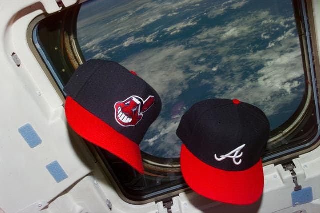 NASA image: Baseball caps of the Atlanta Braves and Cleveland Indians in the flight deck