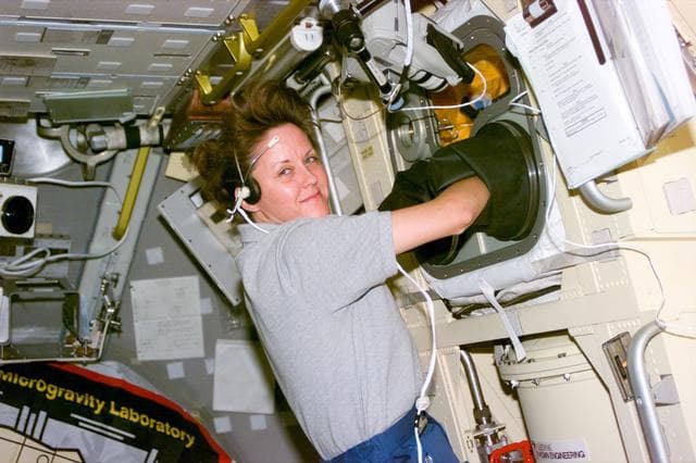 NASA image: Astronaut Kathy Thornton works at Spacelab glovebox